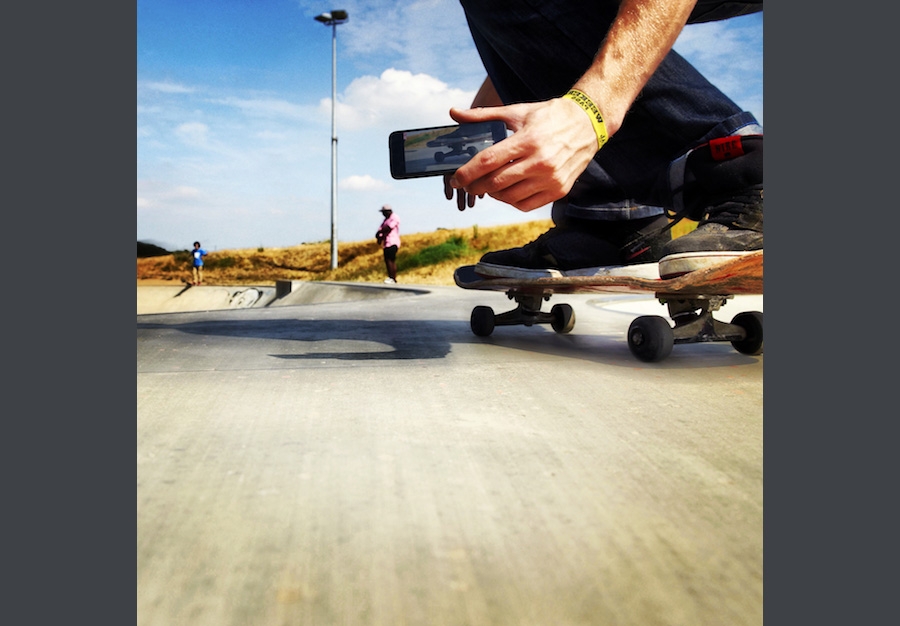 Making a video recording of skateboarding using a mobile phone.