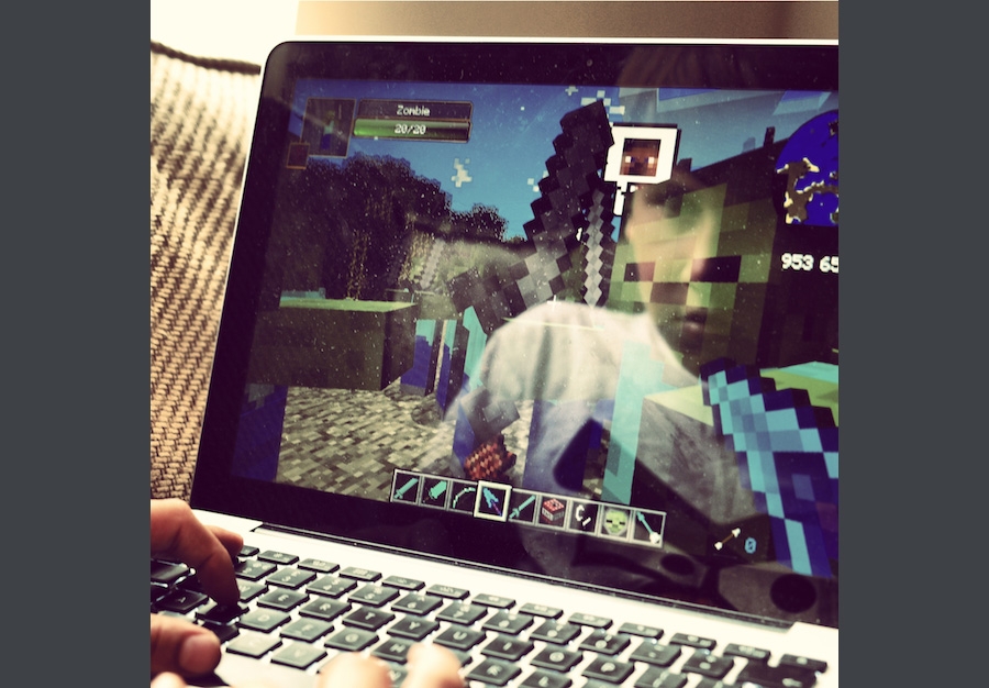 Playing a video game on a laptop.