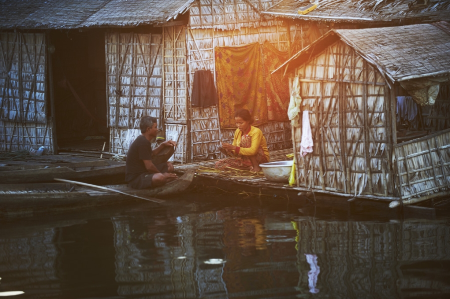 Couple communicating in floating home in Siem Reap.