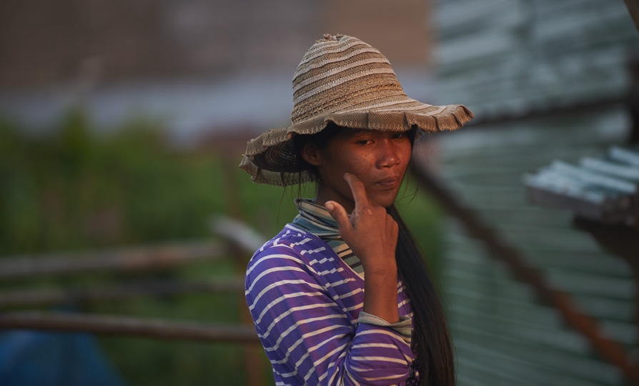 Woman wiping face in Cambodia.