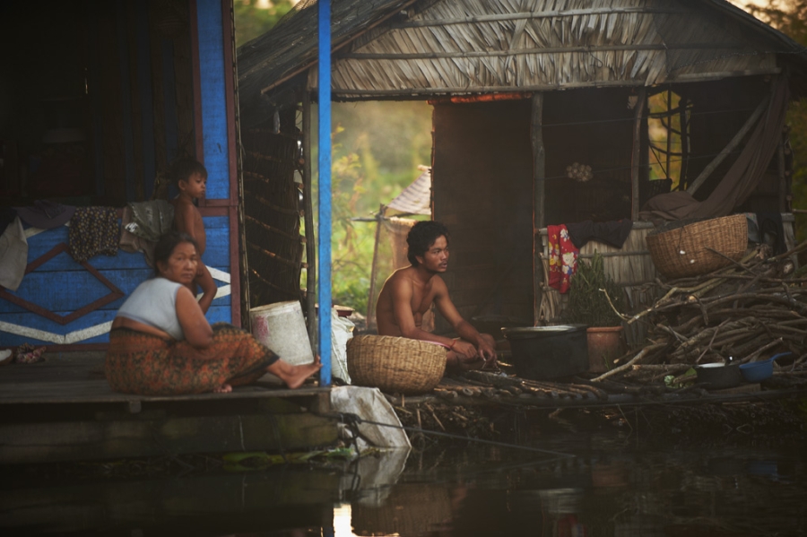 Family sitting together in floating home in Siem Reap.