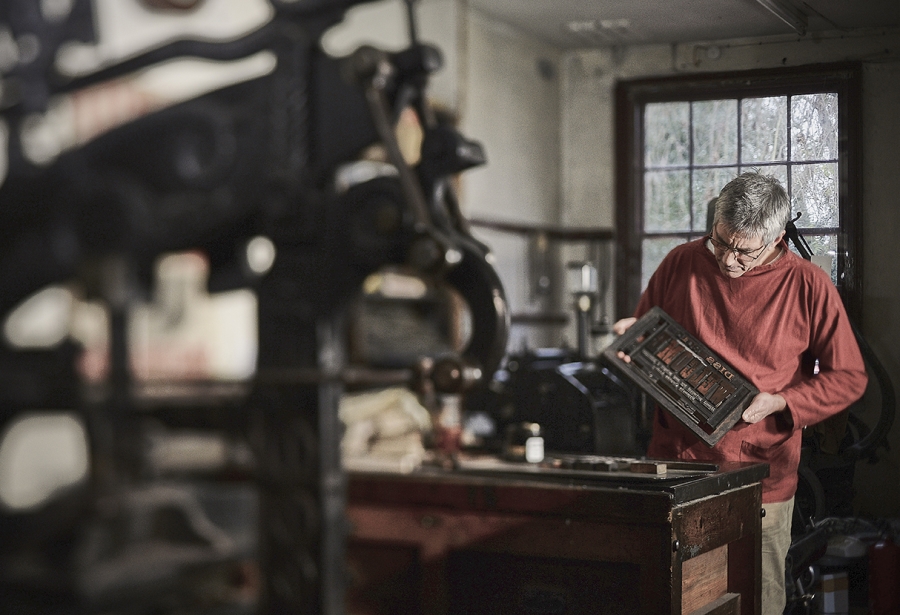 Man setting letterpress.