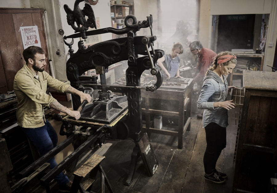 Employees at a letterpress company hard at work.